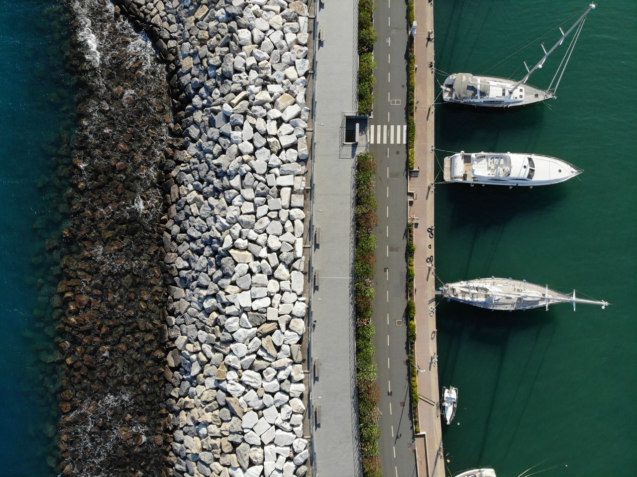 Boats docked in the slips of a marina, seen from above